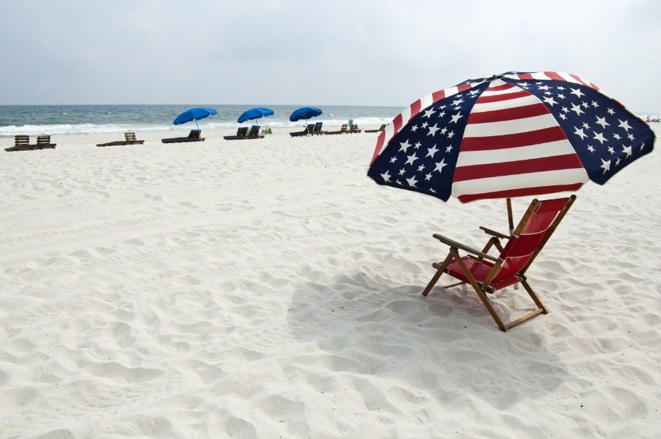 American flag parasol over beach chair on Orange Beach, Alabama